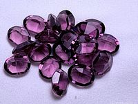 Group of oval rhodolite garnets showing color and cut