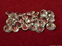 All 22 gemstones grouped on red background showing faceting