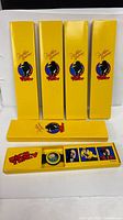 Five yellow Dick Tracy boxes, one open displaying watch and inserts