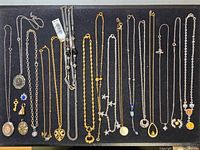 Full view of all necklaces and pendants arranged on black board