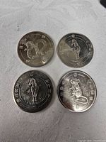 Obverse sides showing snake, horse, horse, rat designs