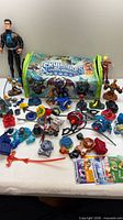Overview of entire Skylanders lot including figures, accessories, cards and storage bag