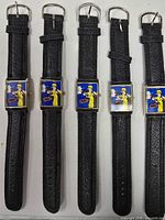 Front view of five identical Dick Tracy wristwatches showing faces and straps