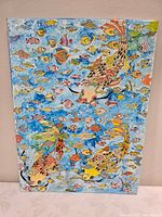 Full view of colourful fish painting on canvas