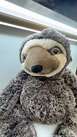 Front view of large plush sloth stuffed animal