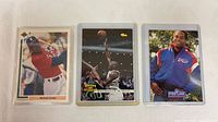 Front view of all three trading cards in sleeves