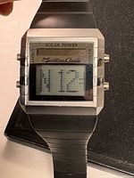 Front view showing dial, solar panel, brand text and LCD display