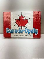 Front of sealed Canada-Opoly board game box showing Canadian flag design