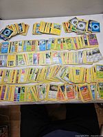 Wide view of entire spread of Pokémon cards on table