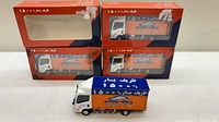 Four ZarifBar Moving Company die-cast trucks, three boxed and one loose
