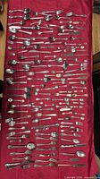 All cutlery pieces laid out on red cloth
