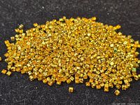 Pile of small amber rhinestones in gold-tone settings