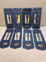Eight watches in original denim pouches on display