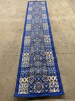 Full view of blue and white runner rug laid flat on floor