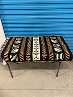 Full view of throw blanket laid flat showing overall pattern and fringe