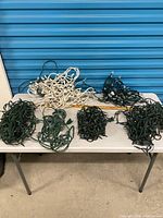 Tabletop view showing all six tangled light sets, white and green wiring