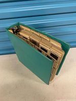 Top view of closed green binder filled with slides