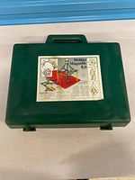 Closed green plastic case with product label