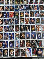 Wide view of bulk stack of Topps WWE 2014 cards laid out showing quantity and variety