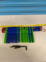 Group of wands, disk magnets on rods, black connectors with tape measure for scale