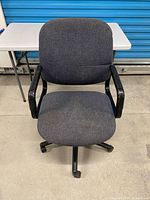 Front view showing seat, backrest, arms, and base