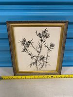 full view of framed artwork with tape for scale