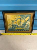 Framed artwork with measuring tape for width