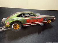 Left profile showing Motorcraft livery, Pony Express decal, gold rear wheel, wheelie bar