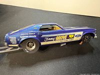 Left side view of blue Mustang drag slot car showing decals and body details