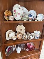 Overall view of china and glassware on hutch shelves