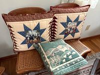 Two quilted pillows and green convertible pillow on bench