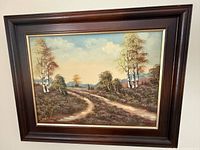 Full view of framed oil painting showing landscape scene and frame