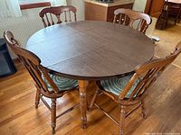 Round dining table with four chairs positioned around it