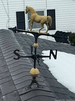 Close view of horse weather vane showing horse figure, arrow, directionals and spacer balls