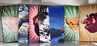 Front view of all seven Lion King #1 variant comics standing side by side