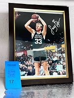 Front view showing signed Larry Bird photo, NBA hologram, frame details