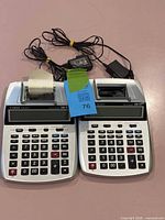 Both Canon P23-DHV calculators with cords and paper roll