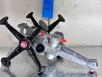 Full view showing body, articulated legs, boom, red lever