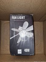 Front of retail box showing fan light graphic and 40W rating