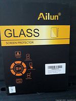 Front of Ailun tempered glass screen protector retail box
