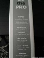 Side of box listing features: less frizz, tourmaline ceramic, up to 410°F, 4 heat settings