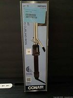 Front of sealed retail box showing Conair curling iron