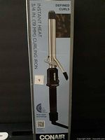 Front view of boxed Conair curling iron showing product image and branding