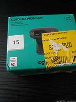 Front of Logitech C270 webcam box with clearance sticker and lot label