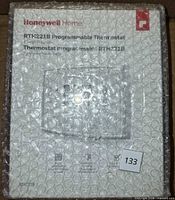 Front view of bubble-wrapped Honeywell Home RTH221B thermostat box