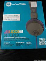 Front of retail box showing brand, model, age range and image of headphones