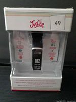 Front view of Justice fitness tracker in clear display box