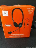 Front of retail box showing ONN 3.5 mm stereo headset image and specs
