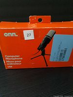 Front of damaged retail box showing ONN computer microphone image and branding