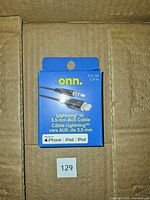 Front of sealed onn. Lightning to 3.5 mm AUX cable box inside shipping carton